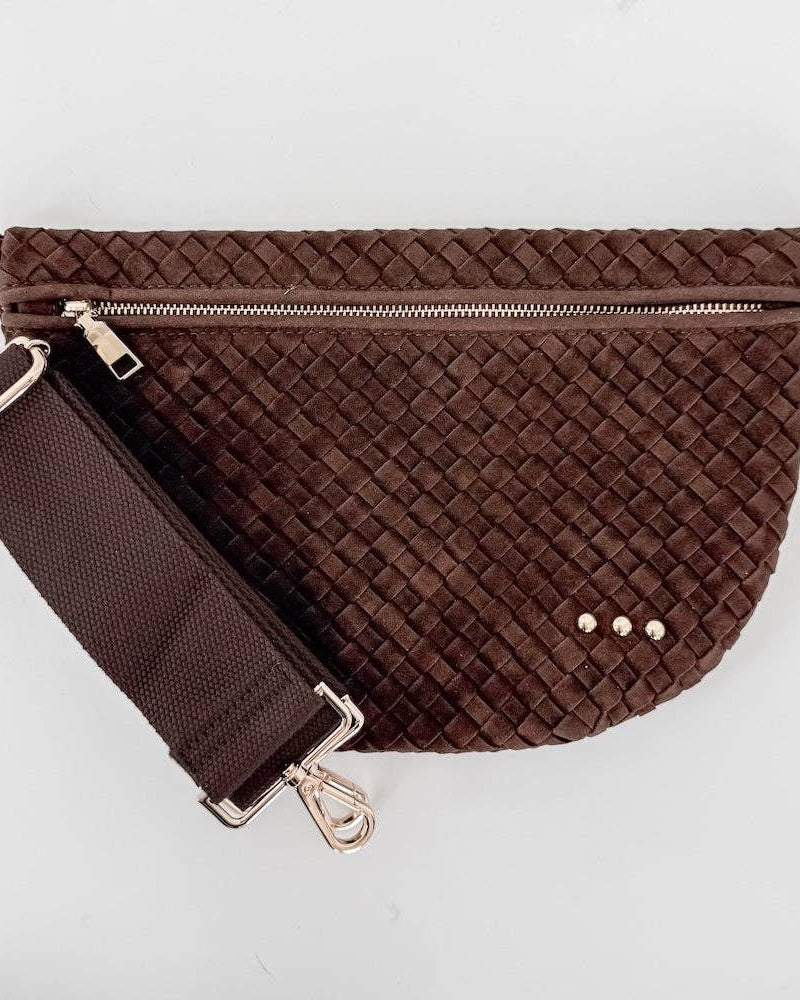Brown woven waist bag with a strap on a light gray background