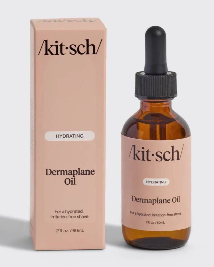 Kit-sch Dermaplane Oil bottle and packaging on a light gray background