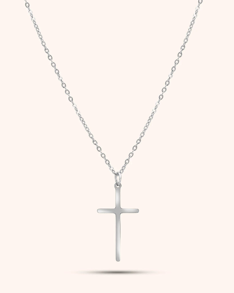 Silver cross necklace on a white background