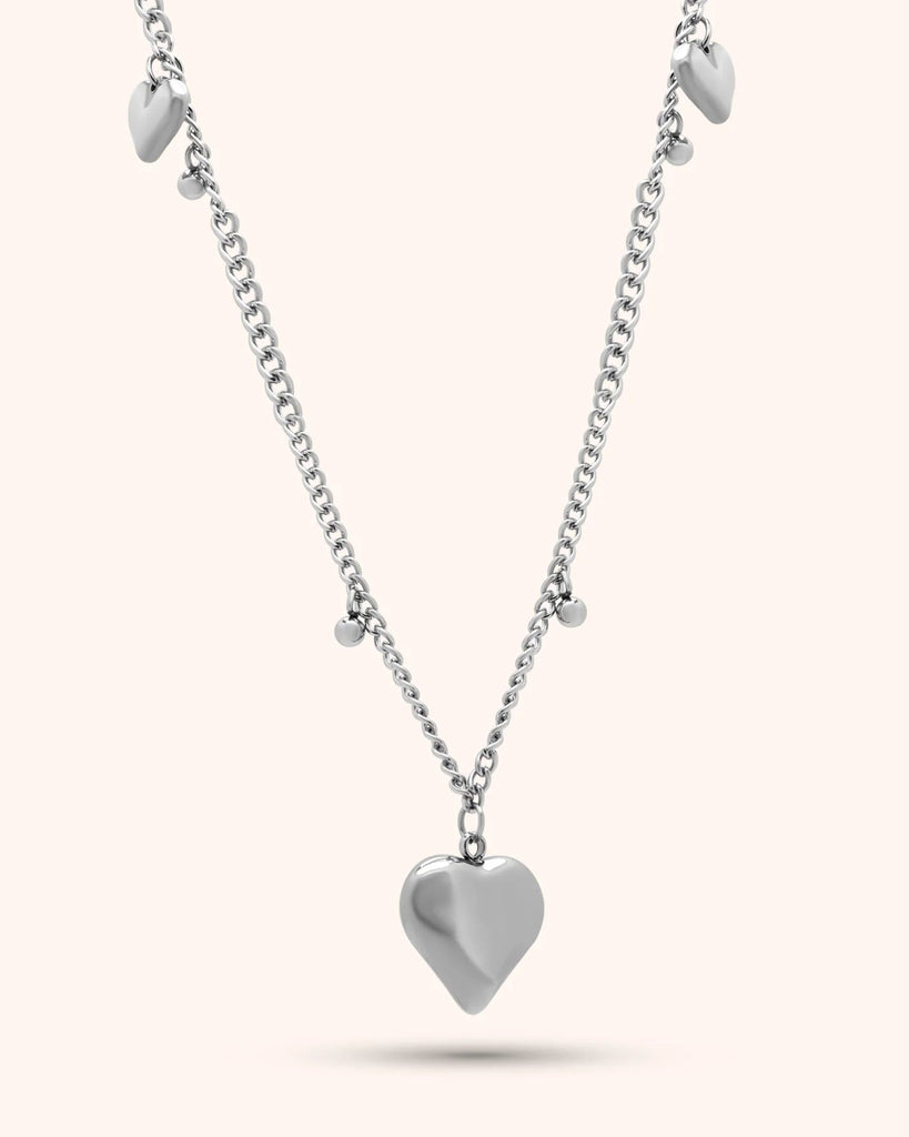 Silver heart-shaped pendant necklace on a white background