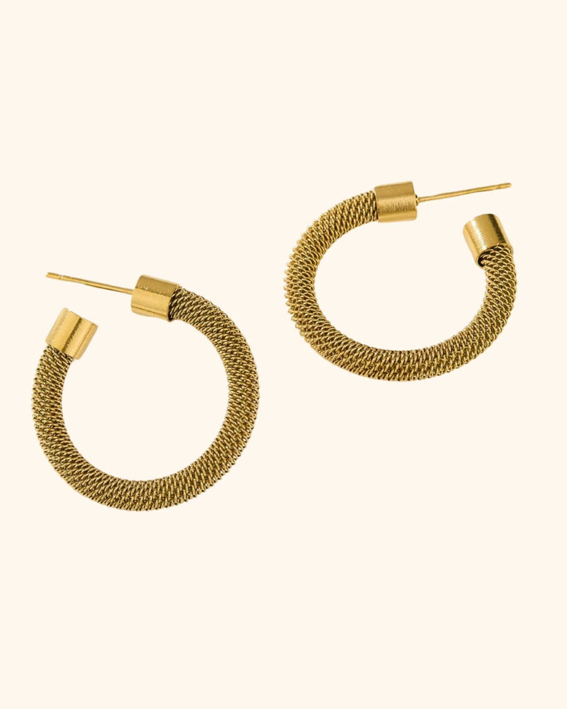 Gold hoop earrings on a white background