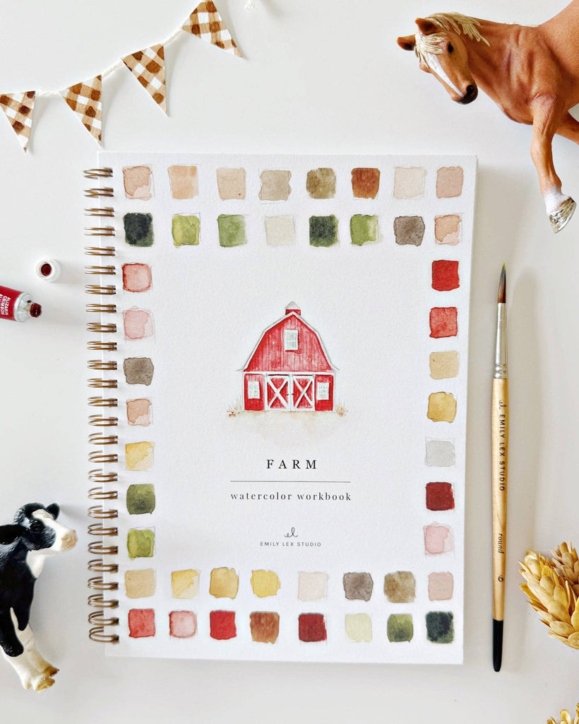 Farm-themed watercolor workbook with a red barn illustration, surrounded by model animals and decor on a white surface.