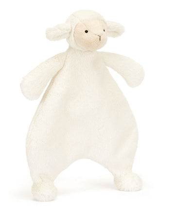 White plush lamb toy on a white background