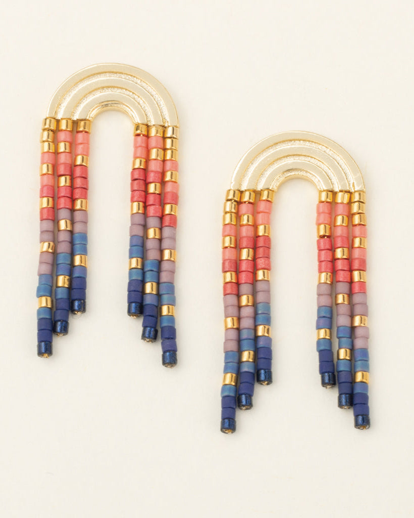 Colorful beaded earrings on a light beige background
