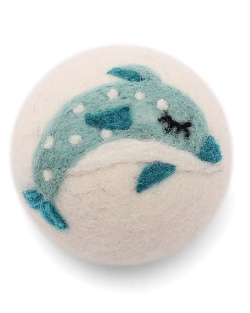 Round felted product with a blue whale design on a white background