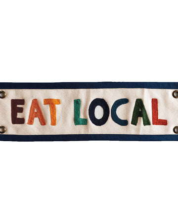 Fabric banner with 'EAT LOCAL' text on a white background