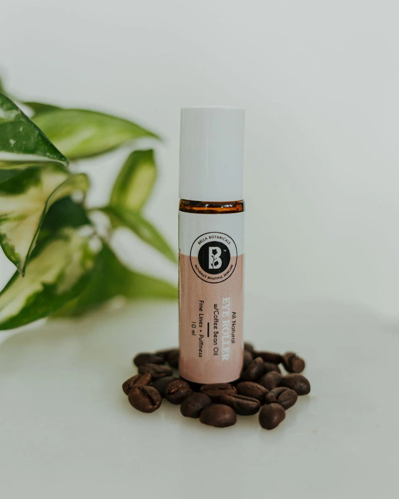 Skincare serum bottle with coffee beans and a plant in the background