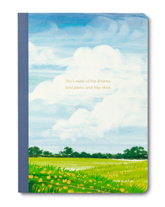 Notebook with a scenic cover of a field and blue sky, featuring text.