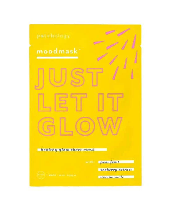 Yellow sheet mask packaging with 'Just Let It Glow' text on a white background