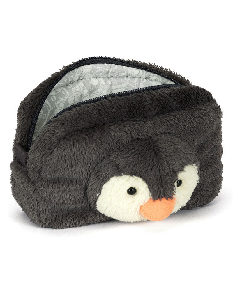 Plush penguin-shaped eye mask on a white background