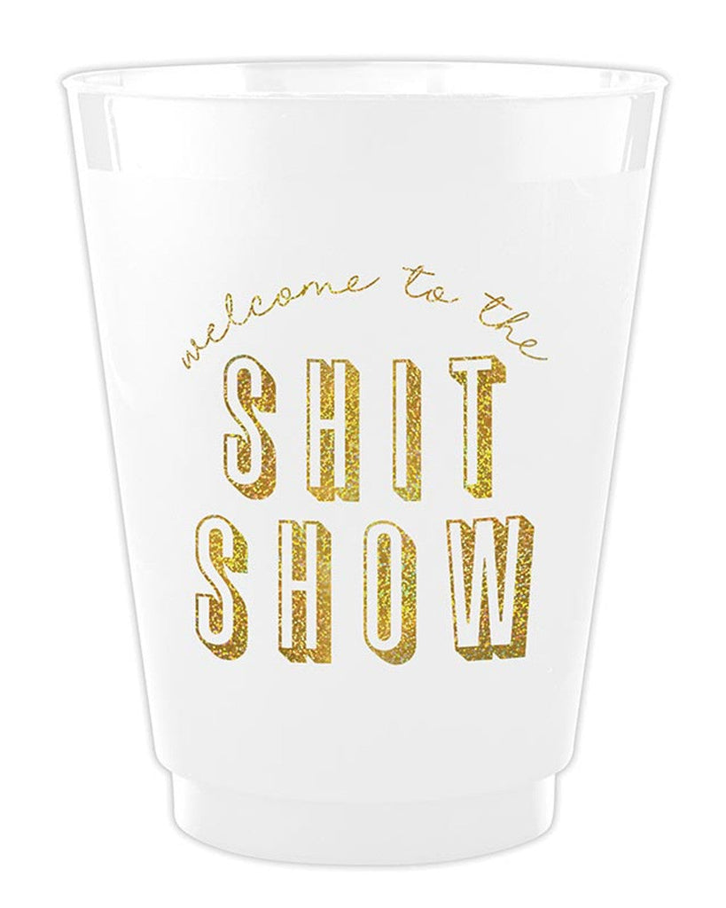 Clear plastic cup with gold text 'welcome to the SHIT SHOW' on a white background