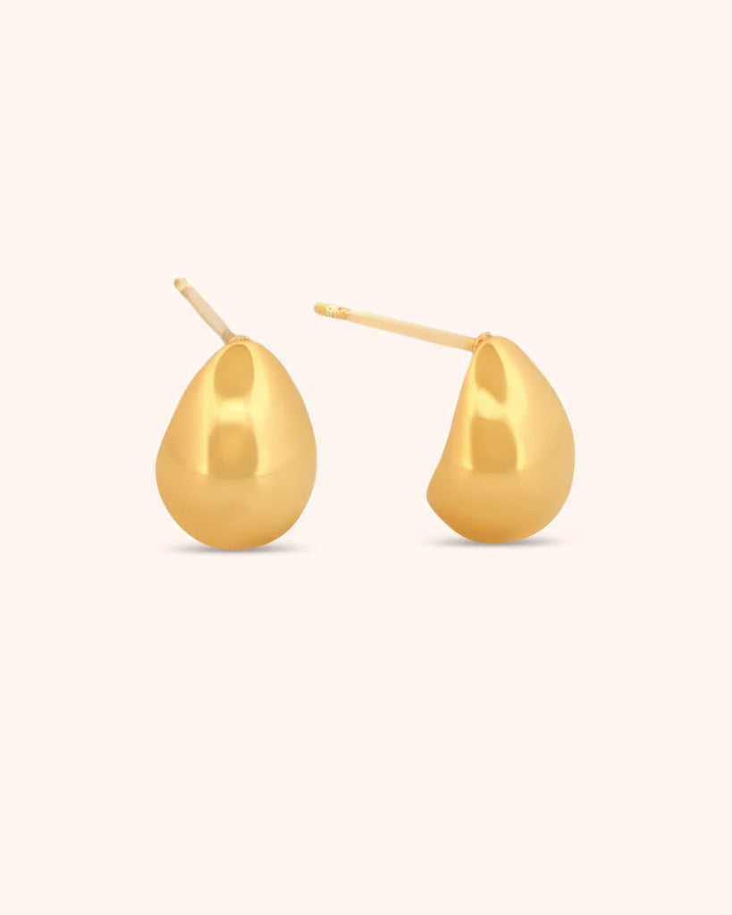 Gold teardrop earrings on a white background