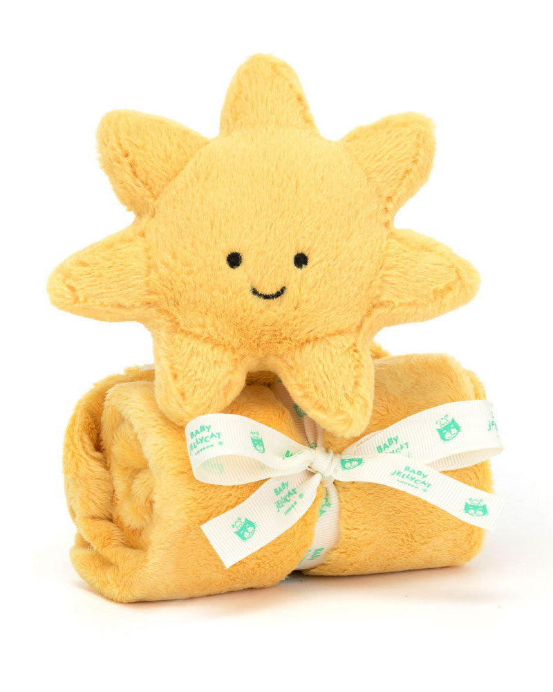 Yellow plush sun-shaped toy with a white blanket and green text on a white background